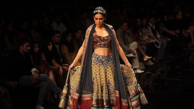 A model showcases a creation by Indian designer J J Vallaya during the Lakme Fashion Week (LFW) Winter/Festive 2011 in Mumbai on August 17, 2011. The LFW, held twice annually, features creations by over 60 designers and will culminate with a grand finale on August 21. AFP PHOTO/Punit PARANJPE *** Local Caption *** 628196-01-08.jpg