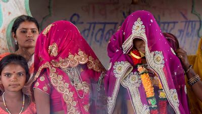 In this April 17, 2017 picture, a child bride, right, stands with family members during her marriage at a Hindu temple near Rajgarh, Madhya Pradesh state, India.. A significant fall in child marriages in South Asia has reduced the rate of marriage for girls globally, the UN children's agency said. Prakash Hatvalne /AP Photo