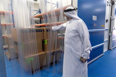 Jehad Abdulmaula, logistics and supply chain expert at IHC in Dubai, shows media the refrigeration facilities which stores medicine destined for India. Antonie Robertson / The National