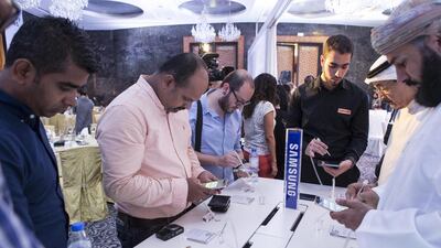 Visitors try the Samsung S6 Edge 6 Plus during the smartphone's launch in Dubai on Tuesday, August 18. Antonie Robertson / The National