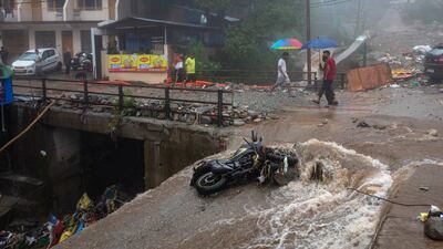 A motorcycle is damaged during flash floods in Himachal Pradesh, India.