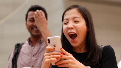 People try the Animoji feature on iPhone X during its launch at the Apple store in Singapore. Edgar Su / Reuters