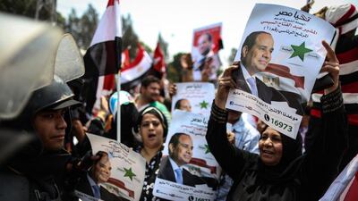 Egyptians hold portraits of Egypt’s new president as they take part in celebrations in front of the presidential palace after Mr El Sisi was sworn in. Mohamed El Shahed/AFP Photo