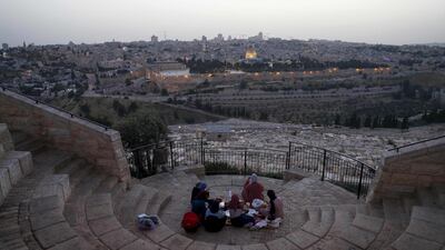 Palestinians gather to break their fast during the Muslim holy month of Ramadan, at the Mount of Olives with a backdrop of the Old City of Jerusalem and the closed al-Aqsa Mosque compound, during the novel coronavirus pandemic crisis. AFP