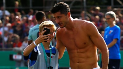 Bayern Munich's Robert Lewandowski poses for a photo with a fan. Reuters