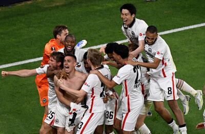 Rafael Borre is mobbed by Eintracht Frankfurt teammates after scoring the winning penalty in the Europa League final. AFP