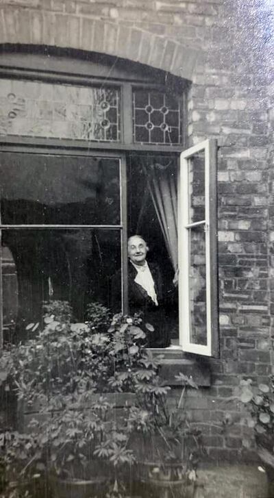 Elizabeth, mother of Jack Donaldson, peeps out the window of her front room in Tynemouth, north-east England. Courtesy John Donaldson