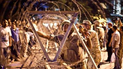 Egyptian army soldiers take out barbed wire that was surrounding the Supreme Constitutional Court in Cairo ahead of planned demonstrations. Virgnie Nguyen Hoang / AFP