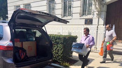 Workers carry boxes out of the Russian consulate in San Francisco as black smoke was seen pouring from a chimney at the stately building in a historic area of the city on Friday. Garance Burke / The Associated Press