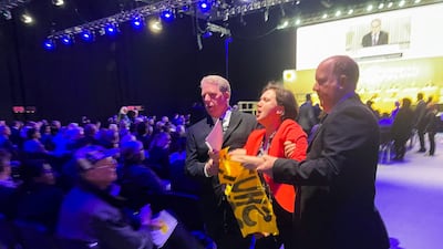 A climate activist is removed from the ExCel Centre in London after disrupting Shell's annual meeting. Reuters