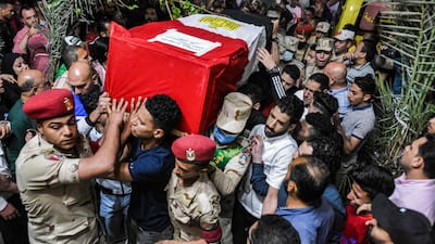 Mourners, soldiers and military police carry the casket of Egyptian Ahmed Mohamed Ali, one of 11 soldiers killed in an attack claimed by ISIS in the Sinai Peninsula. AFP