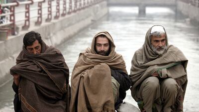 Men shield themselves from the elements in shawls during dense fog and heavy rain in Peshawar, Pakistan. Many cities in the country are experiencing unusually cold conditions of about 5°C during the daytime. EPA