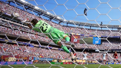 Argentina keeper Emiliano Martinez saves a free-kick from Spain attacker Lamine Yamal. Reuters