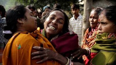 A woman is comforted after hearing of her relative's death from toxic alcohol outside a hospital in Diamond Harbour, near Kolkata, India.