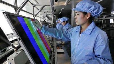 Employees clean and test newly made LED TV screens at a factory in Rizhao, China. Reuters