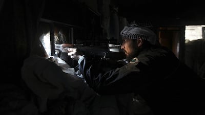 A Syrian rebel takes aim in Deir ez Zor, eastern Syria on February 22, 2014. Khalil Ashawi/Reuters