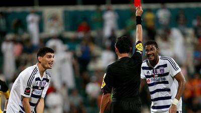Mohanad Salem, left, is shown a red card by the referee last night as Al Ain’s troubles continued on the pitch against Al Shabab. Satish Kumar / The National