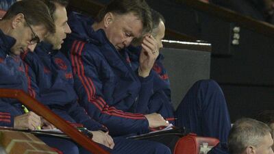 Manchester United manager Louis van Gaal, centre, sits in the dug-out during the English FA Cup third-round football match between Manchester United and Sheffield United at Old Trafford in north west England on January 9, 2016. AFP PHOTO / OLI SCARFF