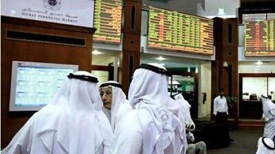 Investors follow trading at the Dubai Financial Market. Marwan Naamani / AFP