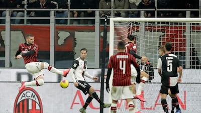 Milan's Ante Rebic, left, scores against Juve. AP