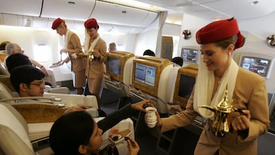 Emirates flight attendants serve passengers during a demonstration flight of the Boeing 777 long-haul aircraft in Dubai in 2007. AFP