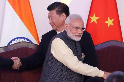 Indian Prime Minister Narendra Modi, front, and Chinese President Xi Jinping during a Brics summit in Goa, India, in 2016. India and China have sought to de-escalate tensions following a fatal clash along a disputed border. AP Photo