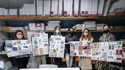Students from Abu Dhabi hold up their presentations, following their third class.