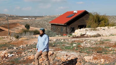Nati Rom walks next to an Airbnb apartment located in the Esh Kodesh outpost near the Jewish settlemtn of Shilo in the occupied West Bank on November 20, 2018. AFP