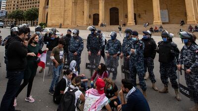 Anti-government protestor shouts slogans in front Lebanese police officers as they try to close the road in front Al-Ameen mosque during a protest against the collapsing Lebanese pound currency and the price hikes of goods, in Beirut, Lebanon. EPA