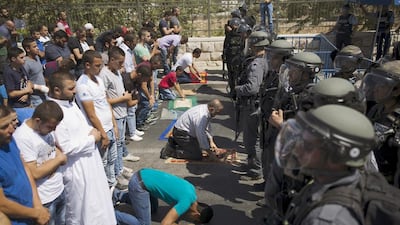 Palestinians who were barred entry from the Al Aqsa mosque were undeterred and resorted to praying outside the Old City's walls instead. Amir Cohen/Reuters