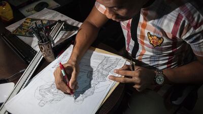 Jide Martins, founder of Comic Republic, works on a sketch depicting African superheroes for stories set in his native Nigeria. AFP