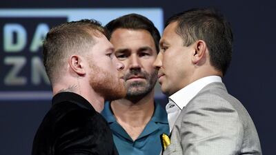Canelo Alvarez and Gennady Golovkin face-off as promoter Eddie Hearn looks on. AFP