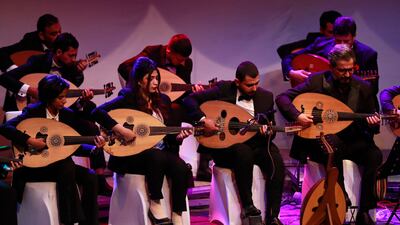 Iraqi musicians play the Oud (Ud, or oriental lute) during a concert at the al-Rasheed theatre in Iraq's capital Baghdad on December 17, 2021. (Photo by AHMAD AL-RUBAYE / AFP)