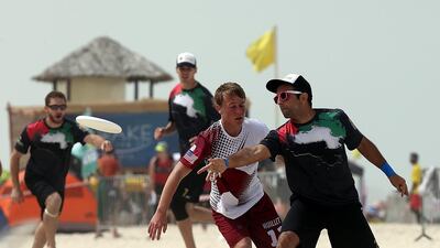 Qatar (White) and UAE (Black) in action during the 2015 World Championships of Beach Ultimate (WCBU) at the JBR beach in Dubai. Satish Kumar / The National