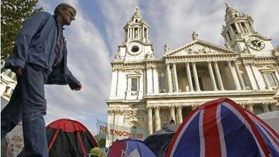 A man walks-by the Occupy London camp area outside St Paul's Cathedral in London this week. Anti-capitalist protesters continue to camp on the church's ground after legal actions to evict them were suspended.