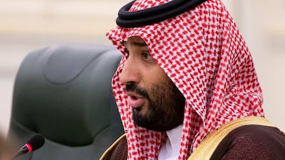 Saudi Arabia's Crown Prince Mohammed bin Salman speaks to Mr Putin during the talks. EPA