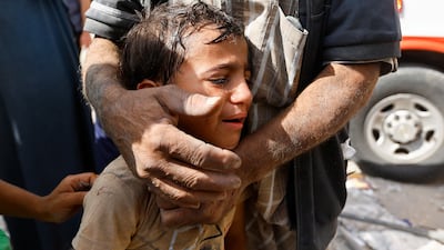 A Palestinian boy cries following Israeli strikes on houses in Rafah. Reuters
