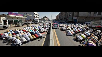 Men face Mecca during Dhuhr prayers on Maliha Street in Sharjah.