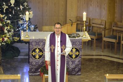 Andrew Thompson leads the Christmas mass service in December 2017 at St Andrews Church in Abu Dhabi. Khushnum Bhandari / The National
