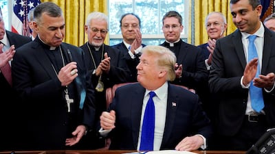 Archbishop Bahar Matti Warda, Archbishop of Erbil and the Chaldean Catholic Archeparchy of Erbil, holds the pen given to him by President Donald Trump after he used it to sign the Iraq and Syria Genocide Relief and Accountability Act of 2018. Reuters