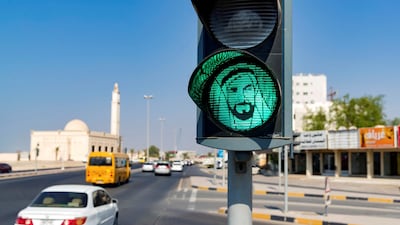 The National's best pictures of the year: A traffic light goes green with the face of Sheikh Zayed in Ajman. Chris Whiteoak/The National
