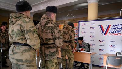 Service members register to vote in Russia's presidential election in Moscow on March 15, 2024. (Photo by NATALIA KOLESNIKOVA / AFP)