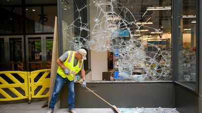 A worker cleans up outside a Nordstrom's along the Nicolette Mall shopping district after protesters and rioters clashed with police in downtown Minneapolis, Minnesota. EPA