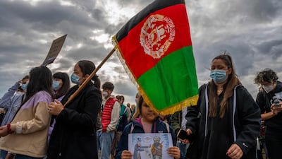 A woman with an Afghan flag is among demonstrators in front of the Reichstag building in Berlin on Tuesday. AFP