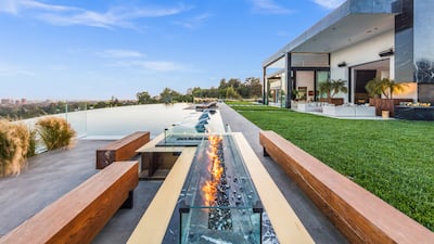 This $88 million LA home sits on more than one acre of land and comes complete with an NFT art gallery, infinity pool, retractable DJ deck and enormous koi pond. Courtesy Joe Bryant