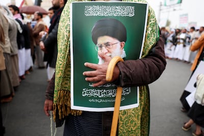 A man clutches a picture of Iran's late Supreme Leader Ayatollah Ali Khamenei, who was killed in an Israeli air strike. Reuters
