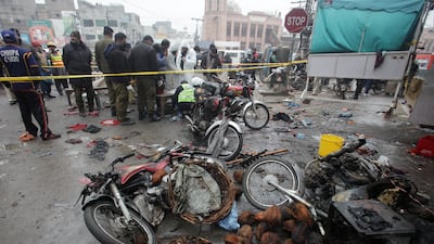Members of crime scene and bomb disposal units gather after an explosion in a market in Lahore, Pakistan. Reuters