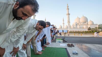 Worshippers celebrate Eid Al Fitr outside Sheikh Zayed Mosque early on Tuesday morning.