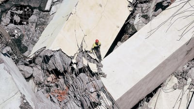 Rescue workers search on the site of the collapsed Morandi Bridge in the port city of Genoa. Reuters