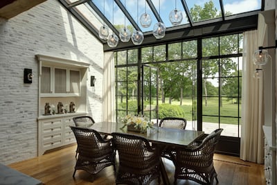 Floor-to-ceiling glass windows flood the space with natural light. Courtesy Landry Design Group